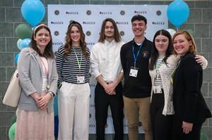 A group photo of Cato-Meridian students in front of a backdrop