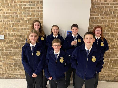 Seven FFA members pose for a photo