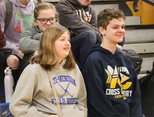 Students look on while seated on the bleachers