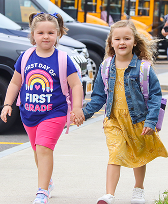 Two students walk to Cato-Meridian Elementary