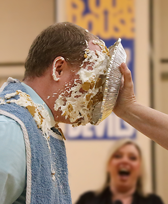  Teacher standing in the gymnasium with pie on his face